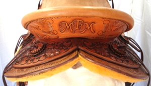 carved initials in cantleback